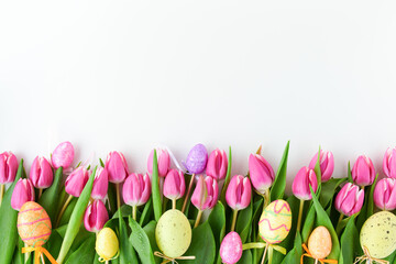 spring flat lay with tulips and easter eggs on white