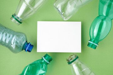 flat lay with plastic bottles isolated on green background