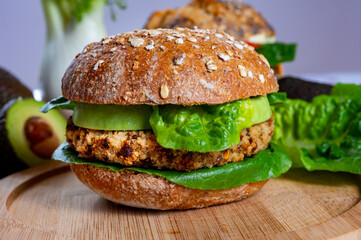 Tasty vegetarian healthy food, homemade burgers made from orange lentils legumes with green lettuce and fresh ripe avocado