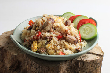 Nasi Goreng Cumi Asin (Fried Rice with Salted Squid), Cooked with Chilli, Spicy and Delicious. Typical Indonesian Homemade Food. Served on Green Plate, isolated on White Background