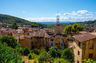 Travel destination, small ancient village Cotignac in Provence, surrounded by vineyards and cliffs with troglodytes houses.