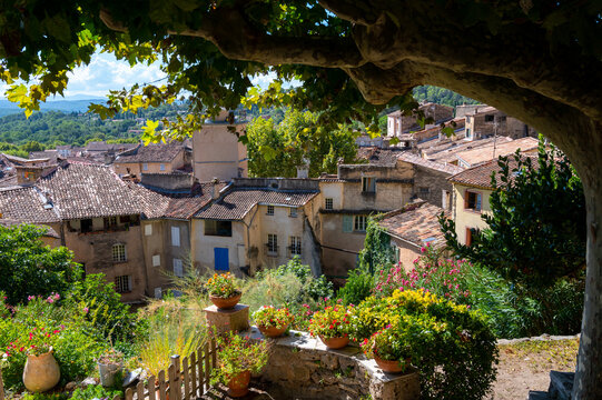 Travel destination, small ancient village Cotignac in Provence, surrounded by vineyards and cliffs with troglodytes houses.