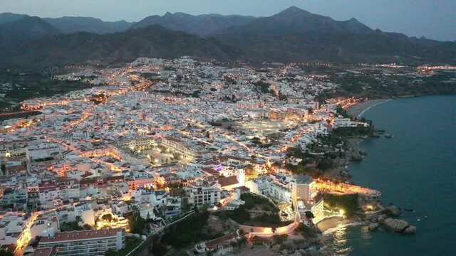 Aerial view of Nerja city with coastline in province of Malaga at night, Andalusia, southern Spain. High quality 4k footage