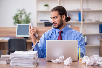 Young male employee in brainstorming concept