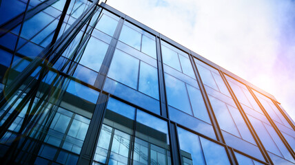 Modern office building with glass facade on a clear sky background. Transparent glass wall of office building.