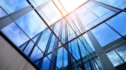 Modern office building with glass facade on a clear sky background. Transparent glass wall of office building.