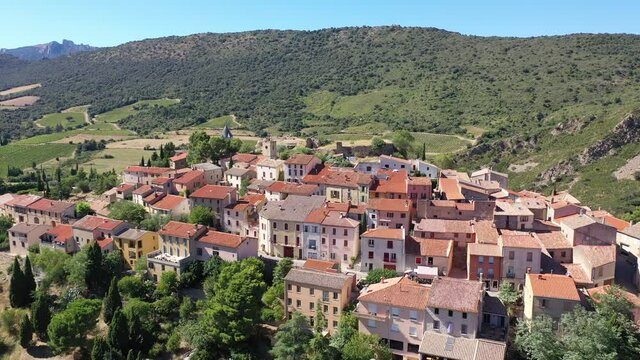 Picturesque aerial view of Cucugnan commune with main landmark 17th-century windmill, Aude department, southern France . High quality 4k footage