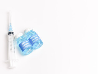 Selective focus COVID 19 VACCINE with syringe isolated on white background.  