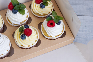 Delicious cream with butter and protein cream, fresh raspberries, blueberries and mint.