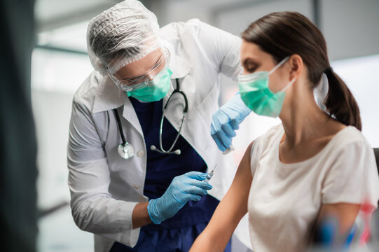 The Covid-19 Vaccine Is Injected Into A Young Woman's Hand.