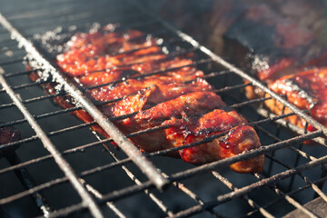 Roasted meet during cooking on the mesh in open fire