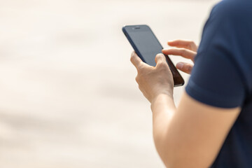 Asian woman using smartphone outdoors