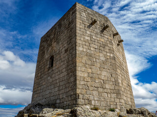 Fototapeta na wymiar Stone squared tower over rocky hill at Guarda, Portugal.