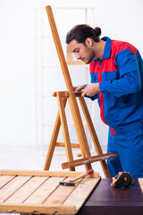 Young male contractor working in workshop