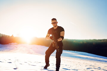 soldier with weapons in forest somewhere above the Arctic Circle