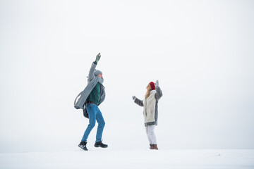 In a winter snow field, two newlyweds play with each other, play with the snow.