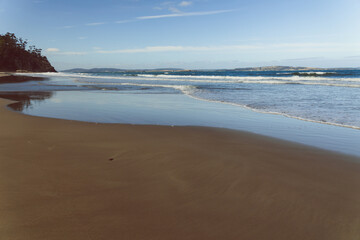  Kingston beach in southern Hobart in Tasmania, Australia on a sunny windy day with intense swell and waves and no people