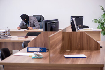 Naklejka premium Young male employee in industrial espionage concept