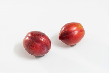 red plums isolated on white background