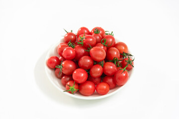 A saucer of cherry tomatoes isolated on white background