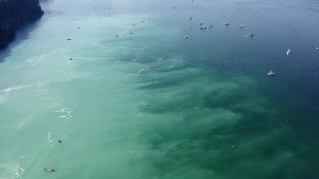 Pull back revealing fishing boats during herring spawn