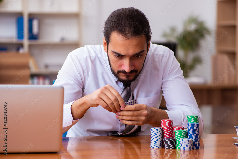 Canvas Prints young male employee in gambling concept