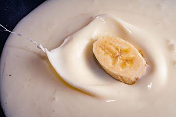 banana splash on white cream yogurt