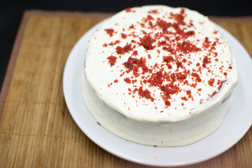 Delicious homemade red velvet cake with fresh berries on black background
