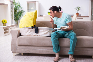 Fototapeta premium Young male parent looking after newborn at home