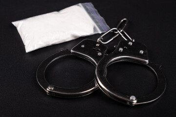 handcuffs and white powder closeup ,drug arrest