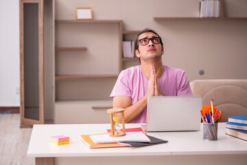 Young male student in time management concept