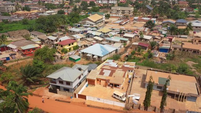 Aerial neighborhood residential Accra Ghana Africa 4K. West Africa on the Atlantic ocean. Summer residential area with dirt streets, homes, houses, apartments and business. Crowded neighborhood
