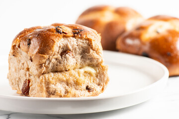 Fresh baked traditional Easter hot cross buns with raisins.