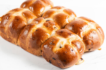 Fresh baked traditional Easter hot cross buns with raisins.