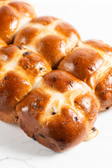 Fresh baked traditional Easter hot cross buns with raisins.