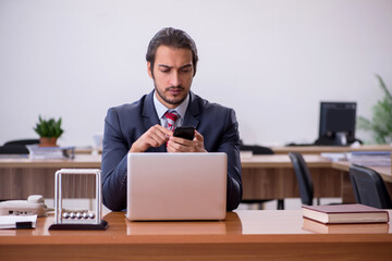 Young man businessman employee sitting in the office