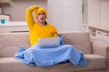 Young man freelancer suffering at home