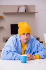 Young man suffering at home
