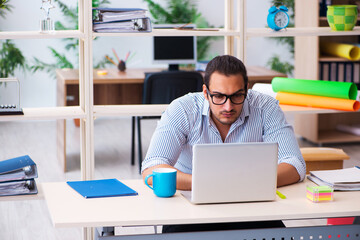 Young male employee working in the office