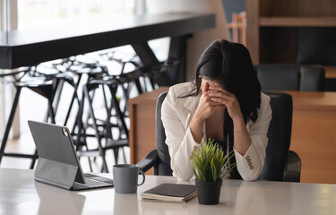 Businesswoman get stressed and headache while having a problem.
