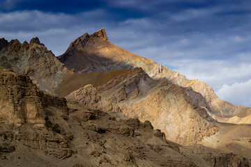 Rocky Himalayan mountian landscape of Kargil with blue cloudy sky in background , green valley , Ladakh, Jammu and Kashmir, India
