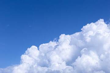 Naklejka na ściany i meble Blue sky background with white clouds. The vast blue sky and clouds sky on sunny day. White fluffy clouds in the blue sky