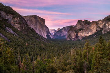 pinkish hue of the sky after sunset in Tunnel View  in Yosemite during summer. From this vantage point you can see the El Capitan and Half Dome.
