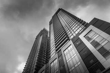 Black and white image of modern condo tower.