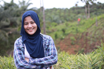 Asian muslim female farmer supervise her ginger plants cultivation. Organic farming