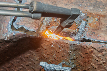 Zoom View Molten Metal and Sparkle from Car Part Removal by Oxygen Acetylene Cutting Technique