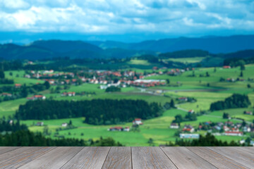 grey wooden aged table top with blurred country side background, farm products stand template