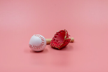 Baseball and glove are on pink background