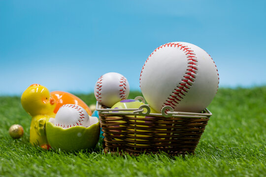 Baseball for Easter Holiday with Easter eggs on green grass