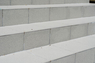 Brown staircase closeup. The steps are covered with ceramic tile